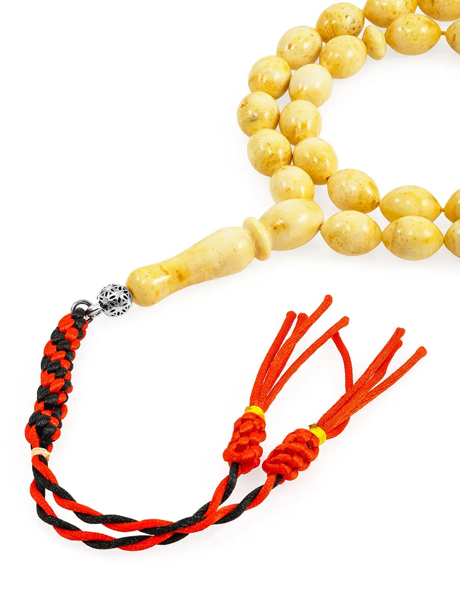 картинка Чётки из формованного молочного янтаря с красным плетёным хвостом в онлайн магазине