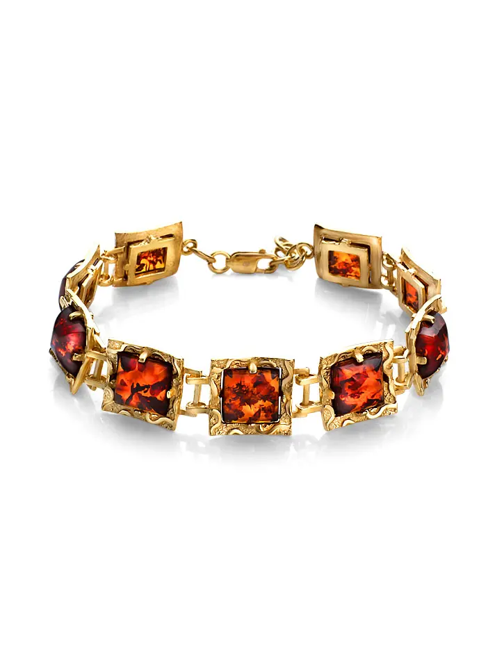картинка Стильный позолоченный браслет «Авангард» с натуральным вишнёвым янтарём в онлайн магазине
